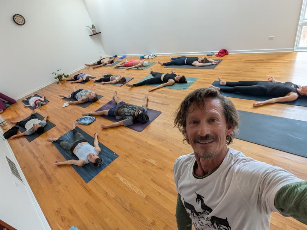 Ashtanga Yoga class at The Cube in Denver - students in savasana with William Mushkin